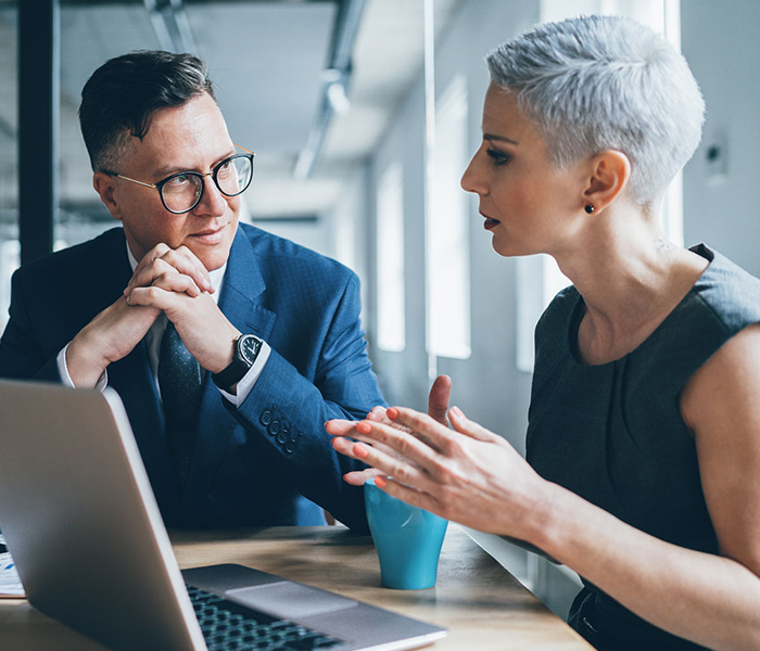 Woman and man looking at laptop