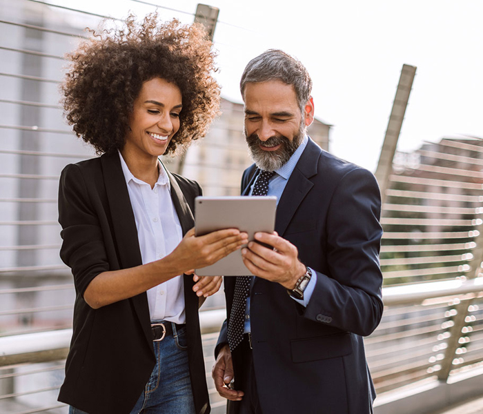 Woman and man looking at laptop